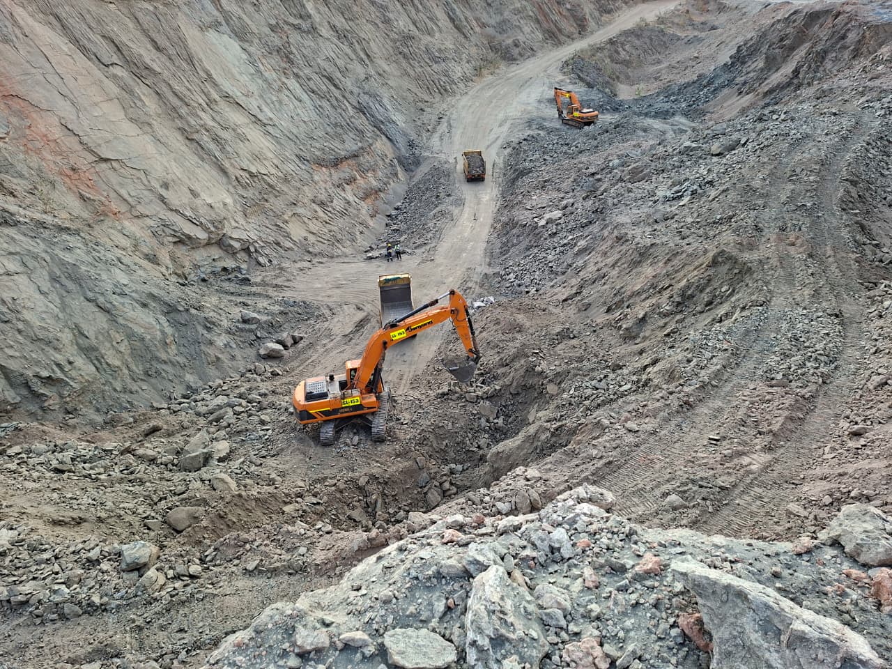 Excavator loading in a deep open pit